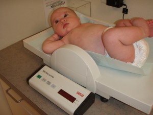 Grace getting weighed -Now twelve LBS and one OZ!!